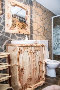 a bathroom with a wooden sink and a mirror at Pensiunea Sarmis in Sarmizegetusa