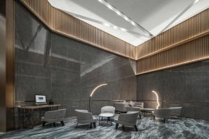 a lobby with chairs and tables and a skylight at Holiday Inn Express Nanchang Bayi Square, an IHG Hotel in Nanchang