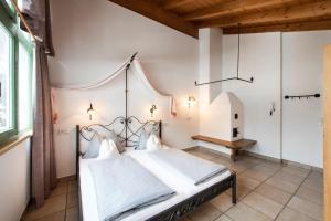 a bedroom with a large bed with a chandelier at RosaMunde Apartments in Leutasch