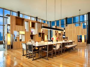 a kitchen with a table, chairs, and a large window at PARKROYAL COLLECTION Pickering, Singapore in Singapore