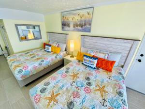 a bedroom with two beds and two pillows at New ! Ocean Reef Resort-Unique Renovated Oceanfront Condo -Free parking - Amazing pools & Views in Myrtle Beach