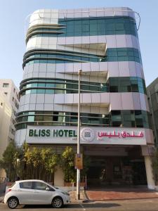 a car parked in front of a glass hotel at BLISS HOTEL L.L.C in Dubai