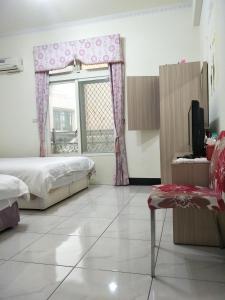 Letto o letti in una camera di 豪鵬遊民宿2館