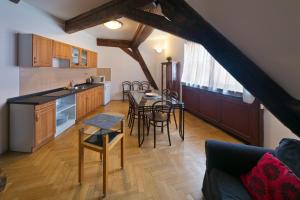 a kitchen and dining room with a table and chairs at Residence u Vejvodů in Prague
