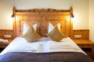 Letto o letti in una camera di Naturhotel Hüttenwirt im Grossarltal