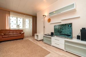 a living room with a couch and a fish tank at Family apartments in Sortavala