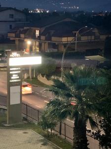 a car driving down a city street at night at Hotel Il Baronetto in Tarsia