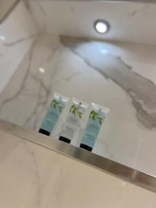 three green and white toothbrushes sitting on a shelf at Ocean Hideaway @ Portmore Bay in Portstewart +18 photos