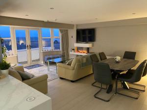 a large living room with a table and chairs at Ocean Hideaway @ Portmore Bay in Portstewart