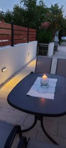 a table with a candle sitting on top of it at Top Location in Živogošće