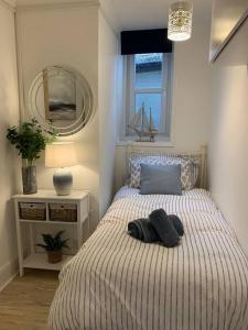 a bedroom with a bed with two towels on it at Casuarina in Ventnor