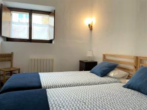 A bed or beds in a room at UNIÓ - Apartamento en el casco antiguo