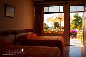 ein Hotelzimmer mit 2 Betten und einem Sonnenschirm in der Unterkunft Amotape Home in Cruz de Pizarro