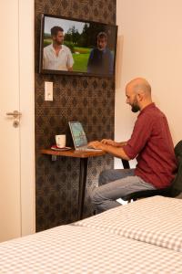 a man sitting in front of a laptop computer at Hotel Burgblick in Bonn