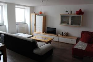 a living room with a couch and a table at ROOMS in SHARED HOUSE SAARBRUCKEN Center in Saarbrücken