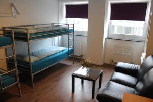 a living room with a bunk bed and a couch at ROOMS in SHARED HOUSE SAARBRUCKEN Center in Saarbrücken