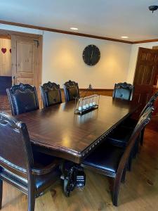 a dining room table with leather chairs around it at Beautiful in town acreage in Lincoln