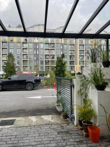 a black car parked in a parking lot with buildings at Premium Garden Home 17 Golden Hills in Brinchang