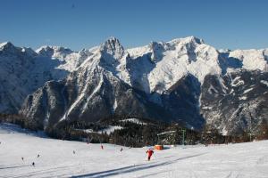a group of people skiing down a snow covered mountain at Ferienwohnung Pyhrgasblick in Rosenau am Hengstpass