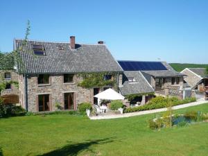 une grande maison en pierre dotée de panneaux solaires dans l'établissement Charming House in Theux with Private Pool, à Theux