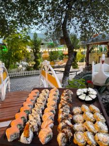 a tray of sushi on a table in a garden at Qafqaz Fountain Villa in Gabala