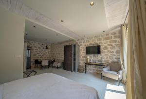 a bedroom with a bed and a living room at Apartments Gabela in Risan
