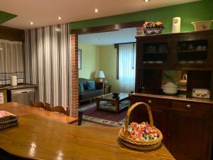 a living room with a table with a basket of candy at Casa La Huerta in Mestas de Con