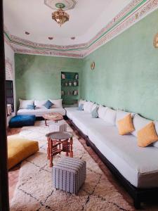 a living room with a large couch and a table at Riad La Residenza in Marrakesh