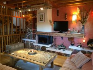 a living room with a coffee table and a tv at La Casa de Bernuy in Bernúy de Porreros