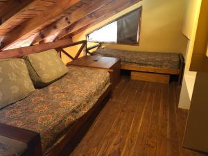 a small room with two beds and a window at Villa del Lago in San Carlos de Bariloche