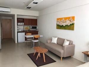 a living room with a couch and a table at Concord Pilar Suite Almendros in Pilar