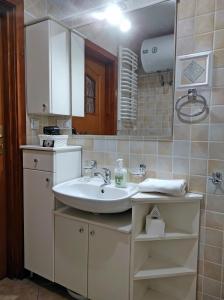 a bathroom with a sink and a mirror at Apartamentylove - Apartament Oliwia in Zakopane