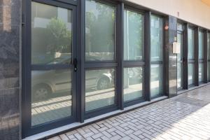 a row of glass doors on a building with a car in it at Charming loft B in Málaga
