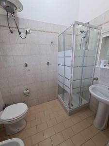 a bathroom with a shower and a toilet and a sink at Casa Michela, sea-view apartments in Trabia