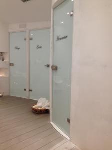 a bathroom with a toilet and a shower stall at Ira Hotel & Spa in Firostefani