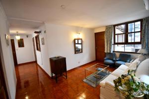 a living room with a couch and a table at Hostal El Cerrito in Salta