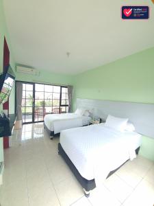 Postel nebo postele na pokoji v ubytování Hotel Griya Wijaya