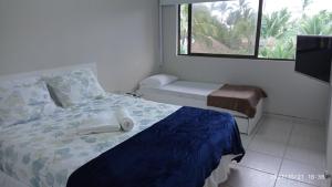a bedroom with a bed and a window at Nannai Residence Porto Galinhas Praia Muro Alto 101 in Porto De Galinhas +52 photos