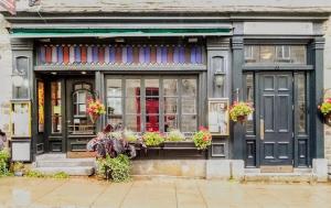 a store with potted plants in front of it at Hotel Louisbourg in Quebec City