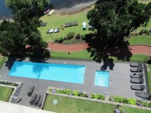 an aerial view of a house with two swimming pools at Parque Pinares 2 dormitorios in Pucón