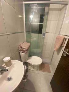 a bathroom with a shower and a toilet and a sink at Smart studio in Cochabamba