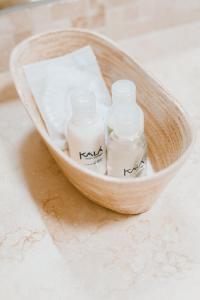 two bottles of soap in a basket on a counter at Kalá Hotel Boutique in Punta del Este