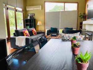 a living room with a table and a couch at Growse House Yarram 3BR in Yarram
