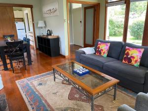 a living room with a couch and a coffee table at Growse House Yarram 3BR in Yarram