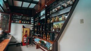 a bar with a bunch of alcohol bottles on the wall at Point 303 Resort in General Luna