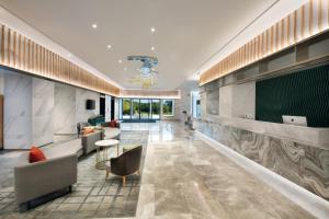 a lobby with couches and chairs in a building at Hangzhou Upper Inn in Hangzhou