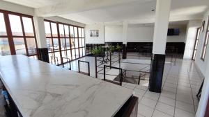 a large kitchen with marble counter tops and tables at Hotel Maeva in Huichapan