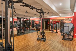 a gym with a lot of exercise equipment at Grand M Hotel in Navoi