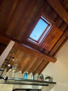 a window in a kitchen with a wooden ceiling at RUBRA Apartments in Parma