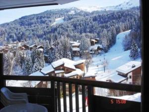 a view of a snow covered mountain from a balcony at Cosy at L'Atrey La Tania in Courchevel